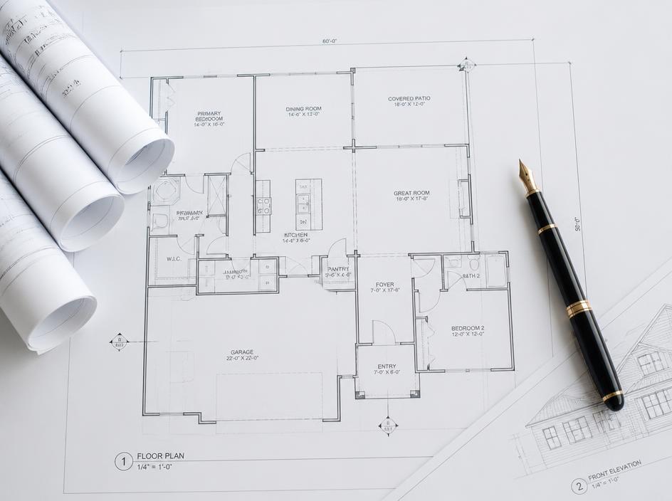 Architectural blueprints and a fountain pen symbolising business development strategy